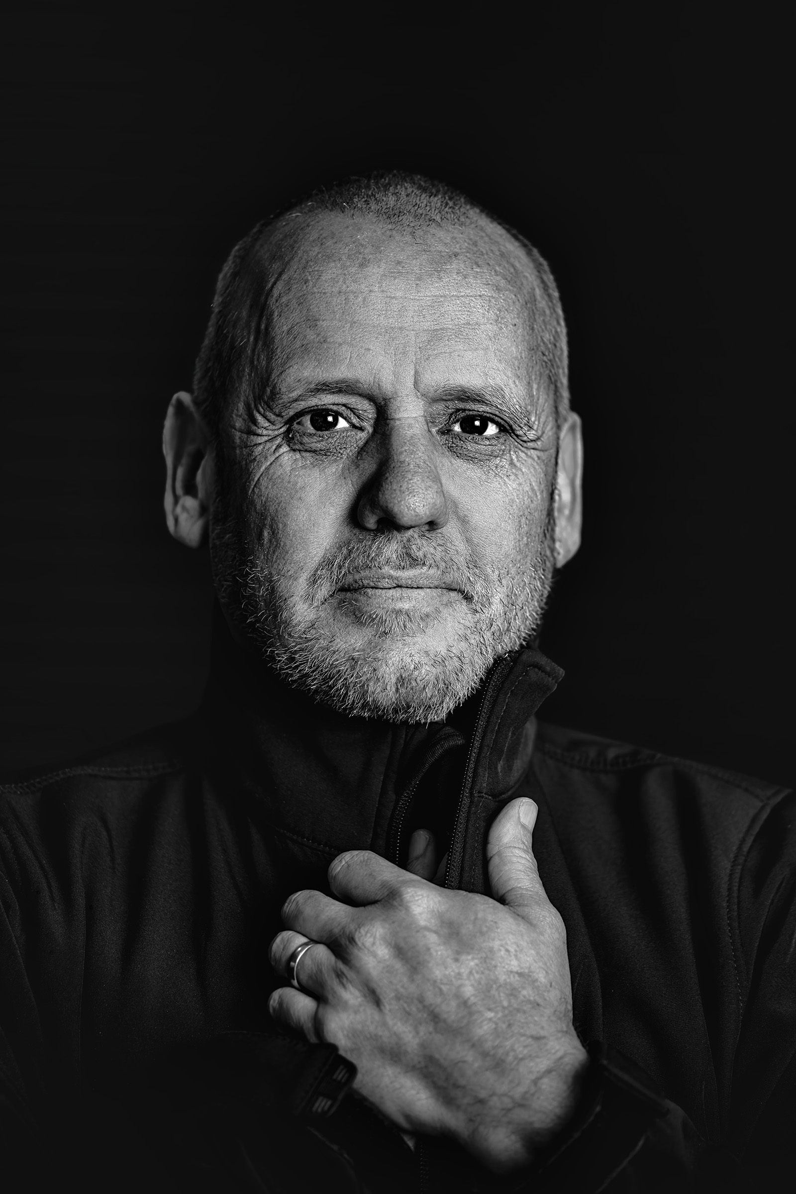 Black-and-white portrait with a natural hand gesture