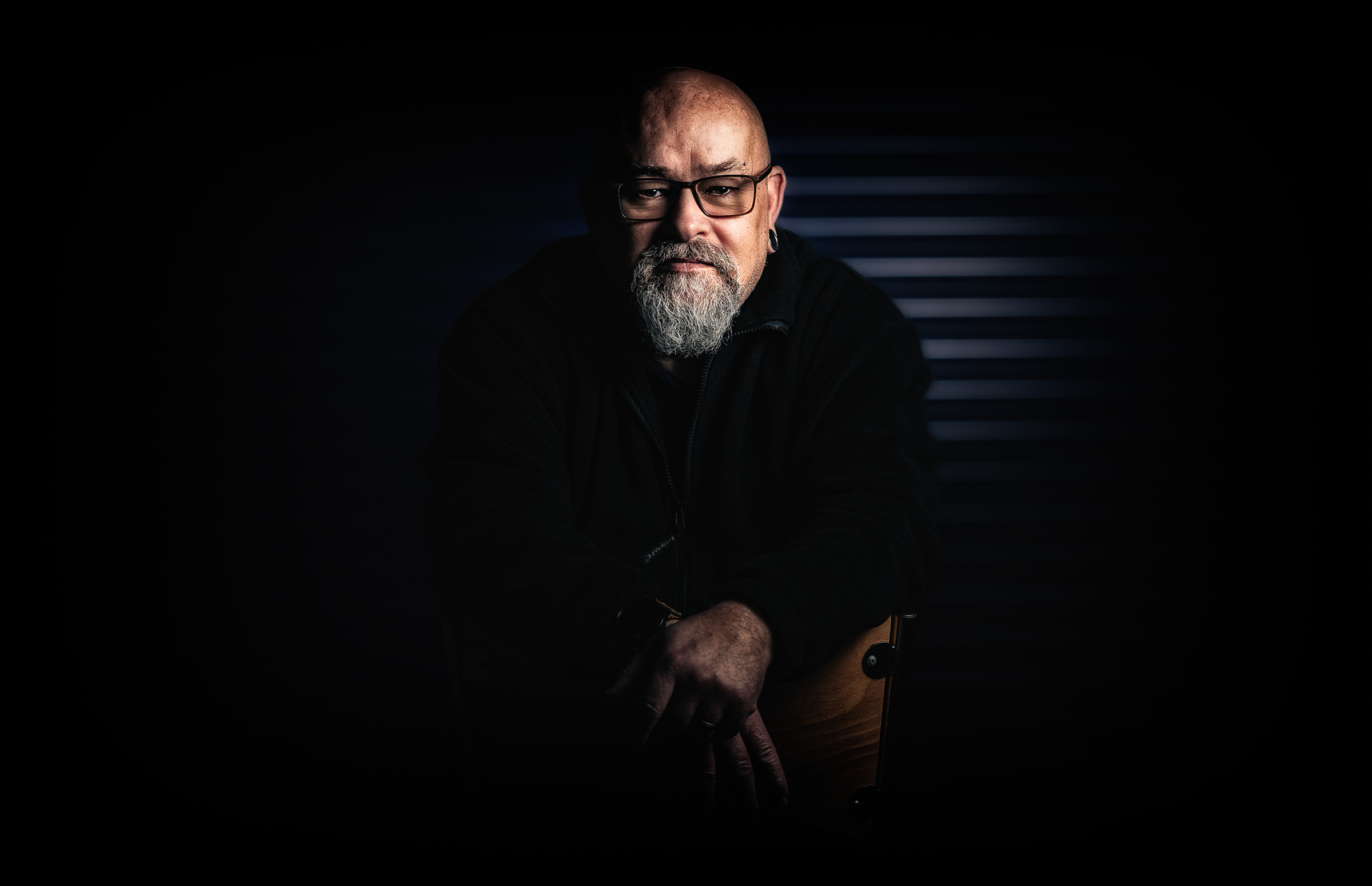 Low-key seated portrait with directional light
