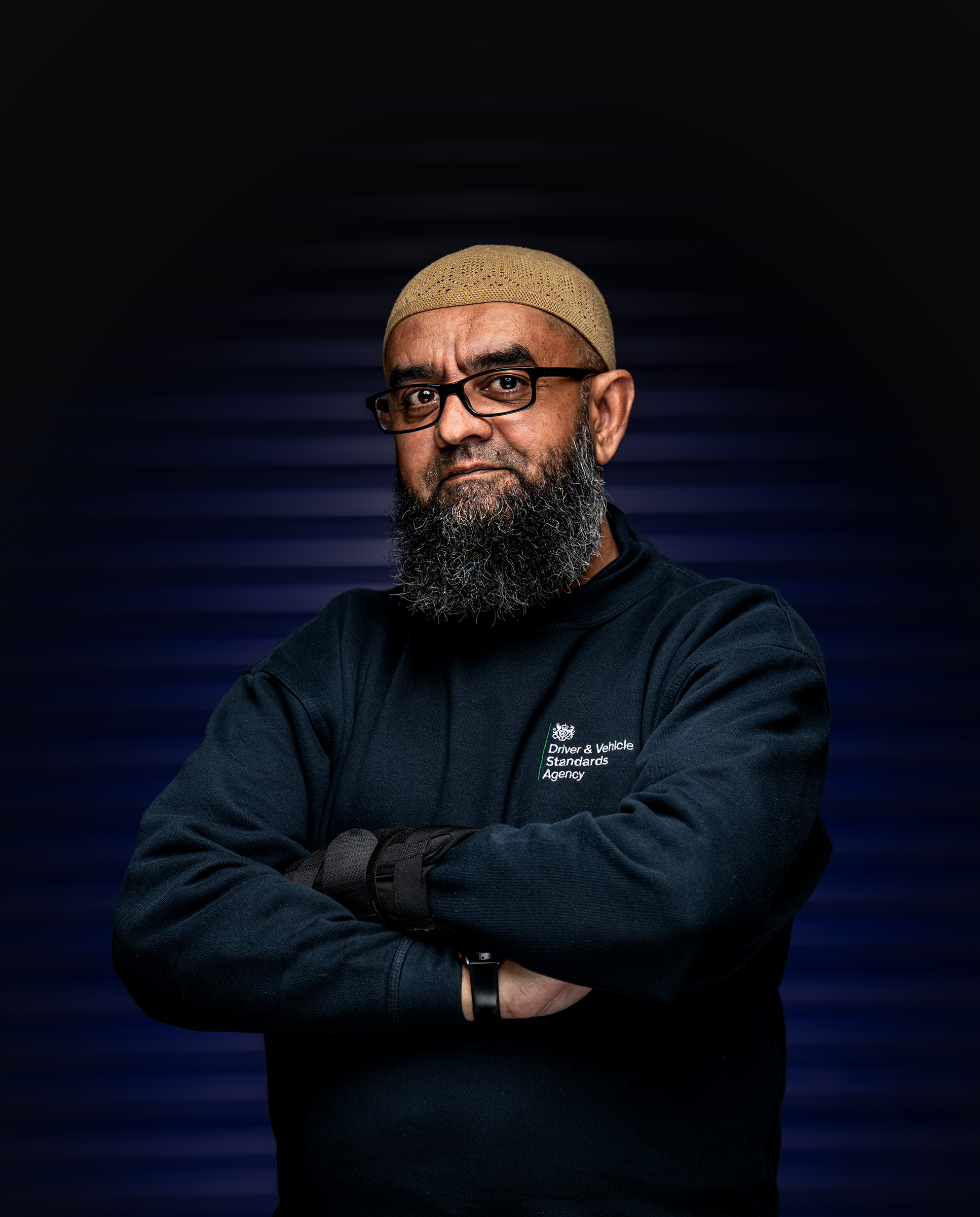 Confident environmental portrait of a man with folded arms