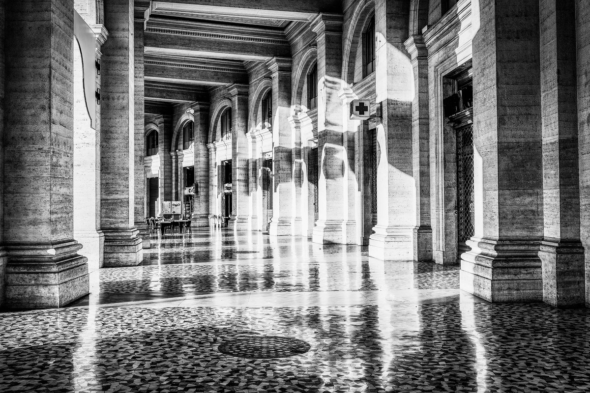 Morning light crossing a colonnade in Rome