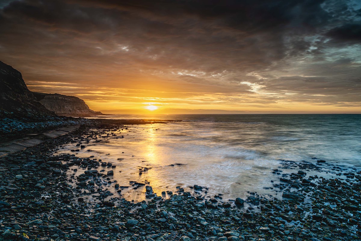Warm evening light over a rocky bay