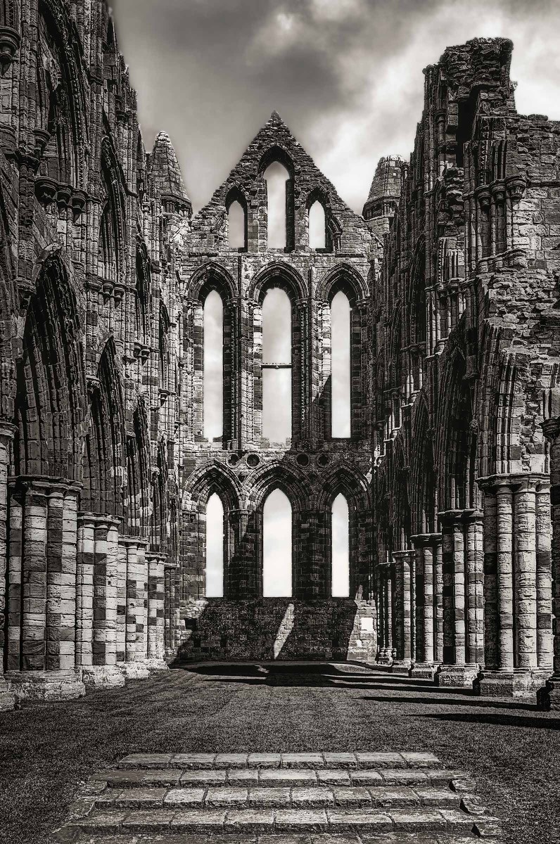 Tall window opening in a ruined stone abbey