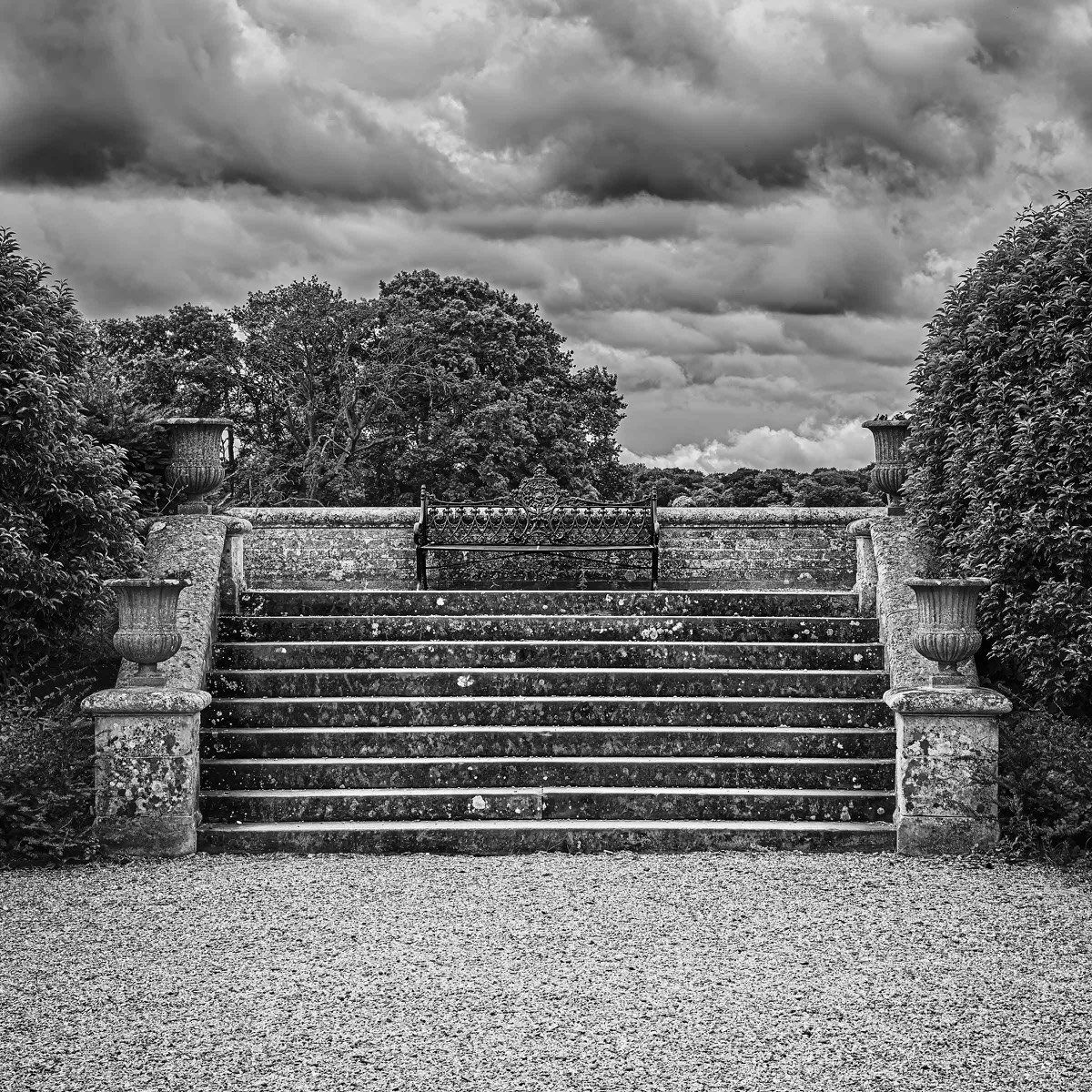 Formal stone steps beneath a dramatic sky